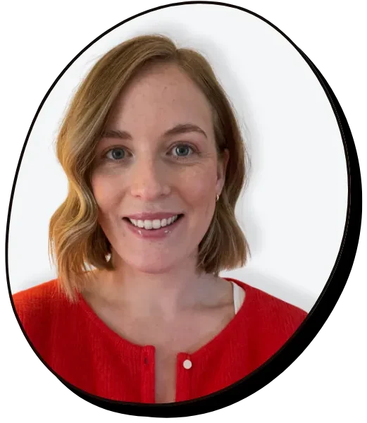 Dr Clare Cullen - Clinical Psychologist smiles at the camera - she is a white woman with a red cardigan, with short blonde hair