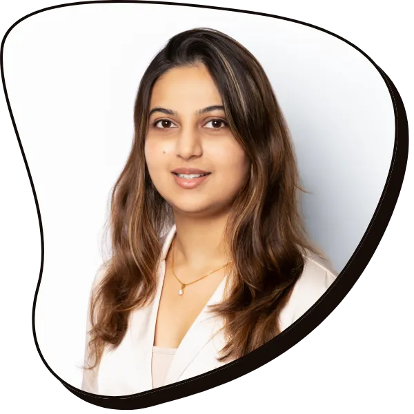 Inaara Somani – Speech & Language Therapist - smiles at the camera, she has brown skin and dark long hair